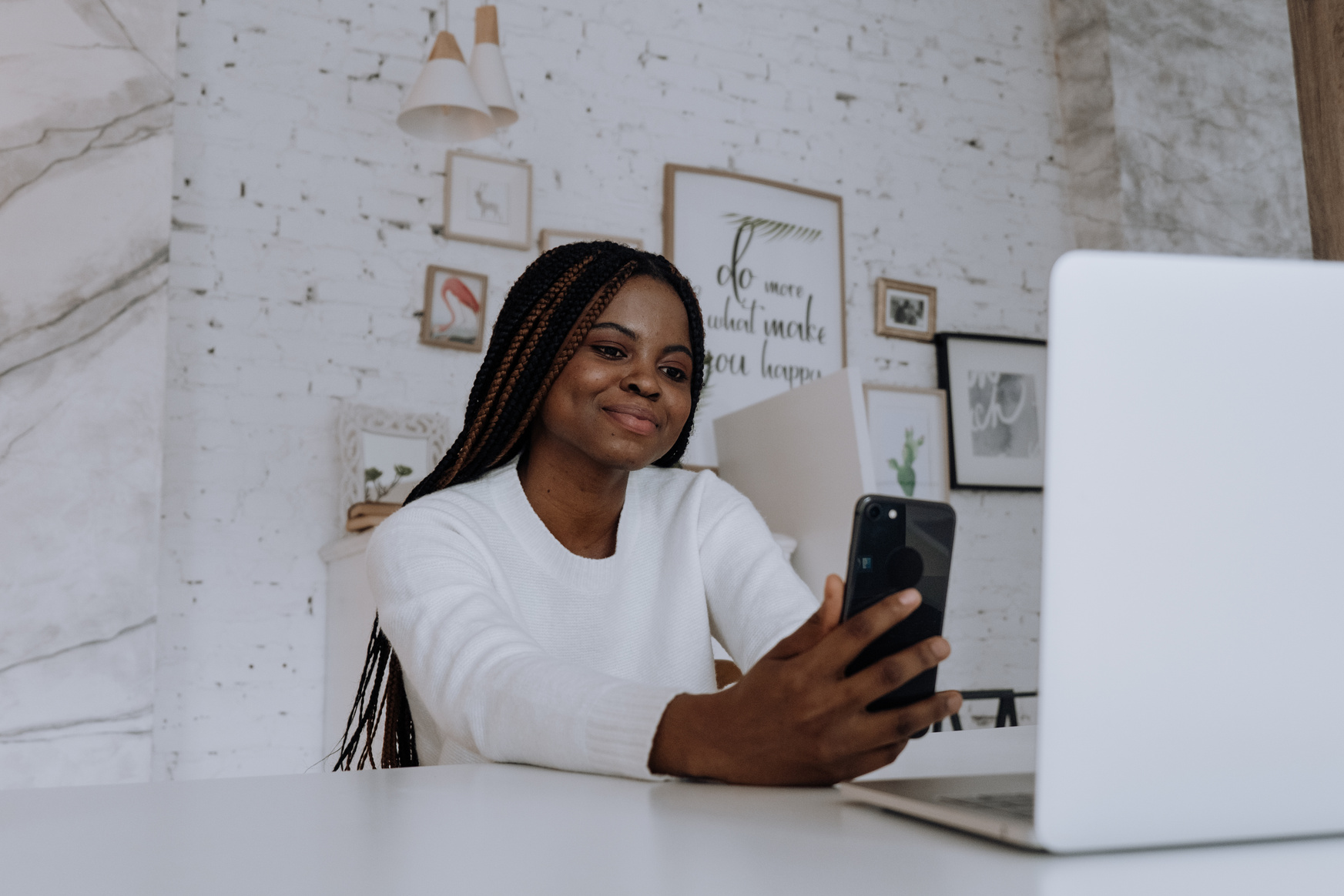 Woman in White Long Sleeve Shirt Holding Black Smartphone